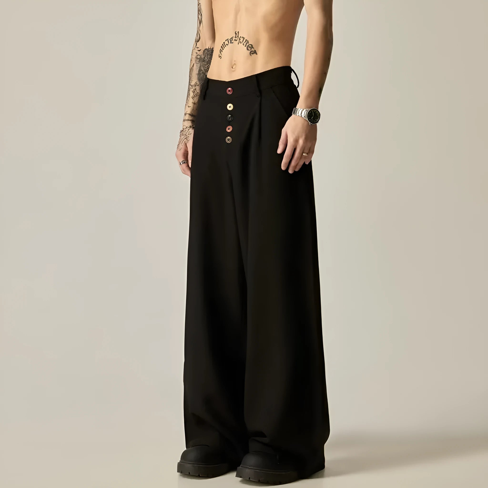 Men's black casual trousers with wide-leg design and button fly closure showing elastic waistband detail