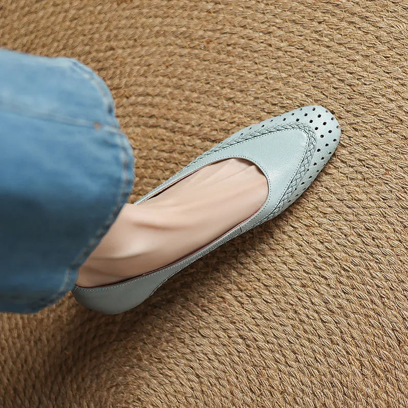 Women's beige sheepskin sandals with hollow-out design, round toe, and mid heel.