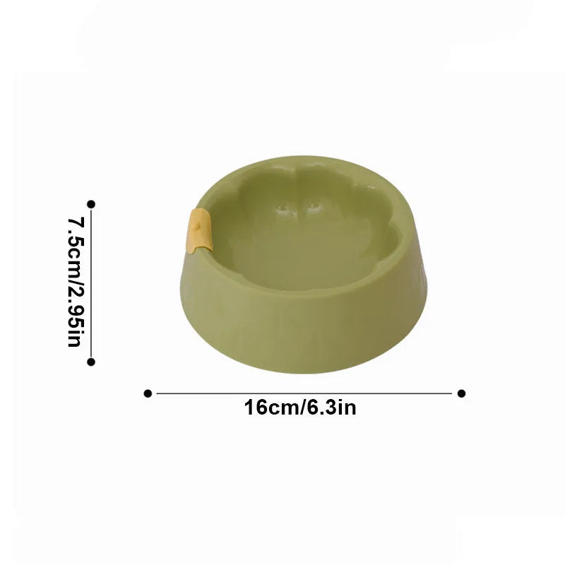 Green plastic double pet bowl for dog and cat food and water on a white background