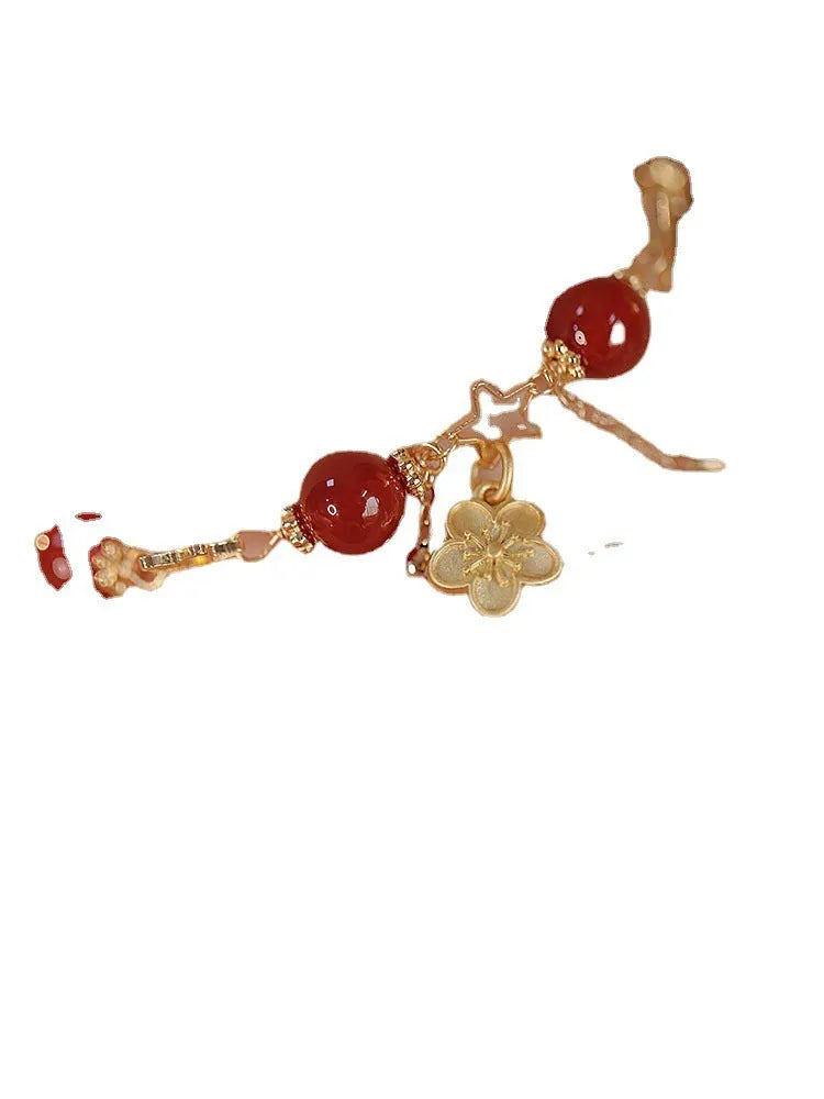 Red agate double layer bracelet with floral and peach blossom design on a wrist