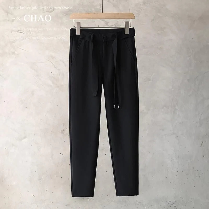 Boy wearing slim straight grey wool blend business casual trousers with a tapered fit
