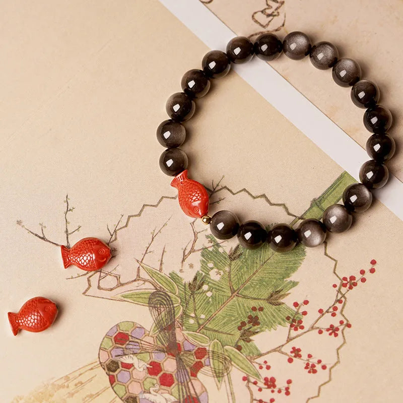 Natural obsidian and cinnabar round bead bracelet shown in 6mm, 8mm, and 10mm size options.