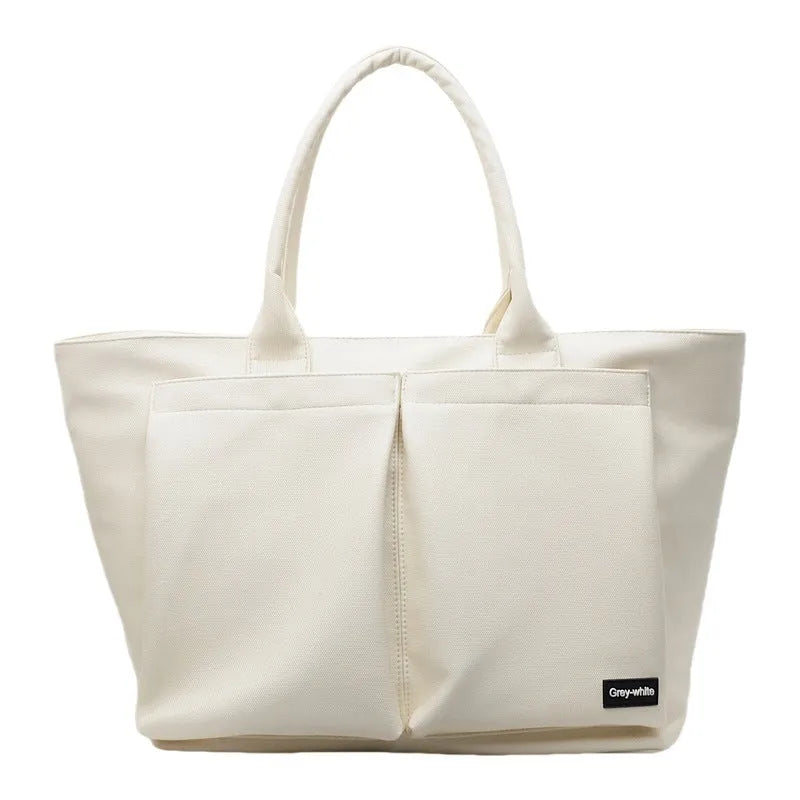 Lightweight expandable PU shoulder bag in black, shown with adjustable strap and sporty design.