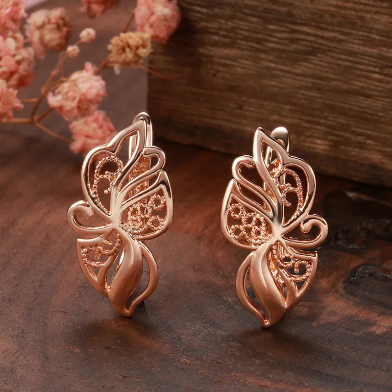 Rose gold copper earrings with hollow carved geometric design and rhinestone accents for women