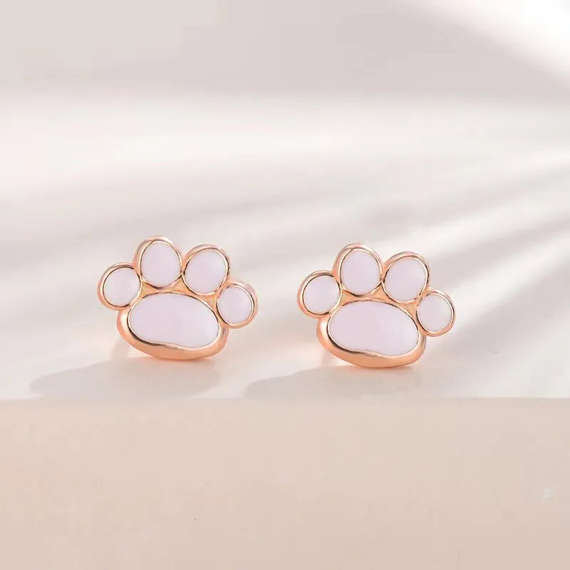 Handmade 925 silver cat paw ear studs in white gold colour finish on a white surface