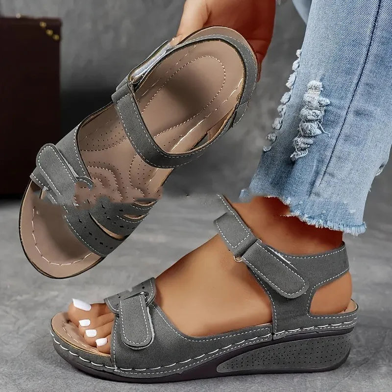 Women's beige strap sandals with a thick composite sole and adjustable Velcro fastening.