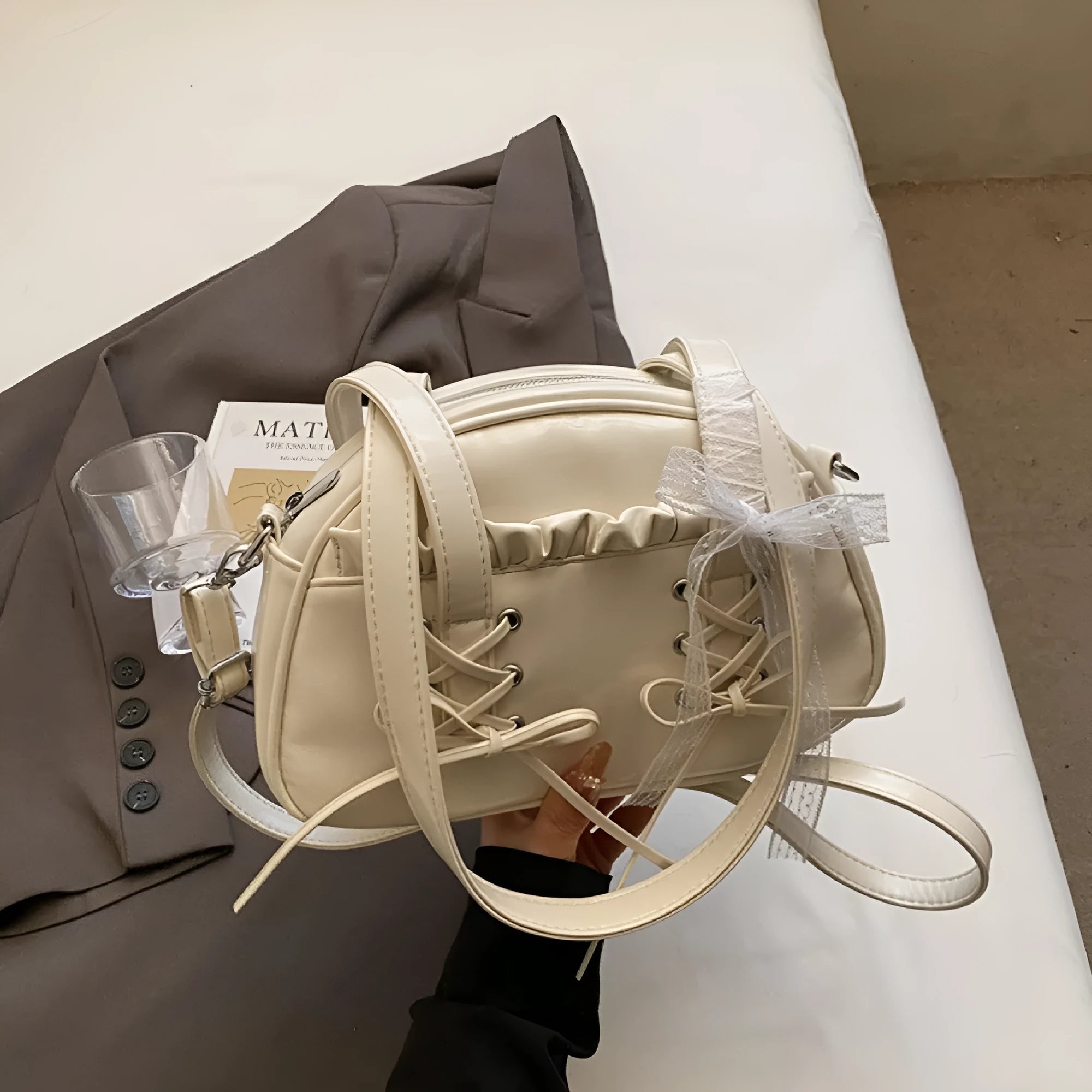 Casual ladies shoulder handbag with bandage bow detail in PU material showing mobile phone compartment
