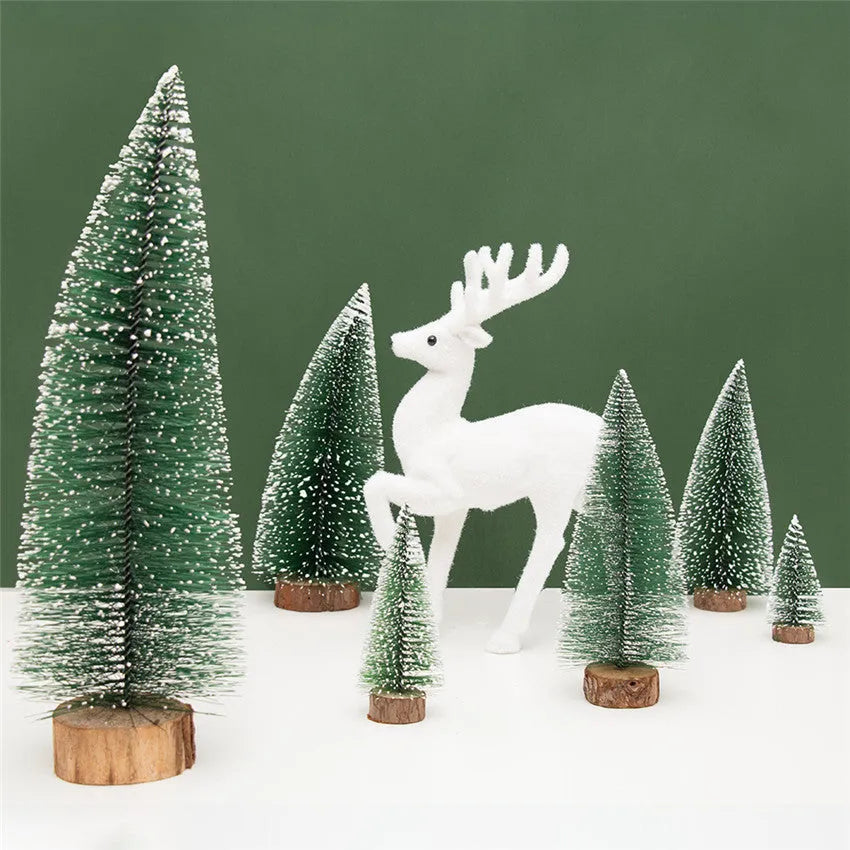 Set of artificial Christmas pine needle trees in green and white, heights 10cm to 30cm, on a tabletop