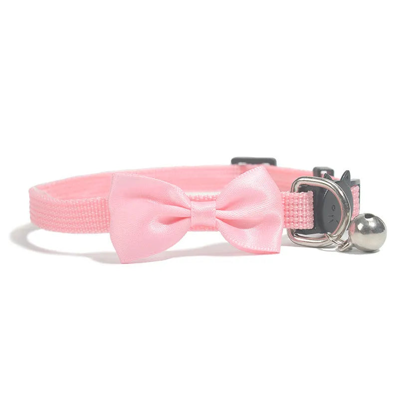 Adjustable nylon cat collar with decorative bow and bell in striped cartoon pattern, multiple colour options shown