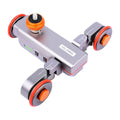 Wolf King L4X mobile camera remote control slide car with black body and silver remote on a tabletop