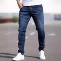 Men's dark blue slim fit cotton jeans showing skinny leg silhouette and street fashion style