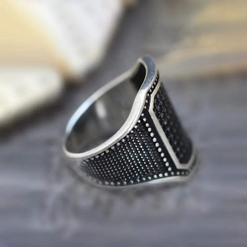 Black alloy ring with copper geometric inlay and cubic zirconia stones
