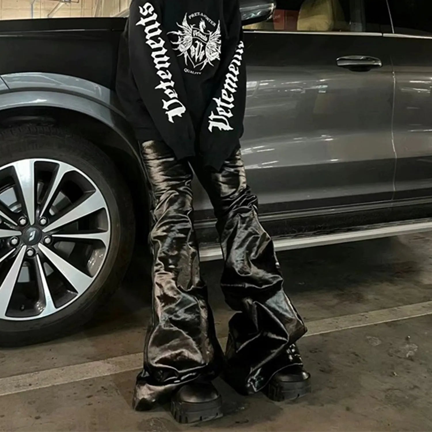 Black shiny patent leather coated straight-leg skinny jeans on a model