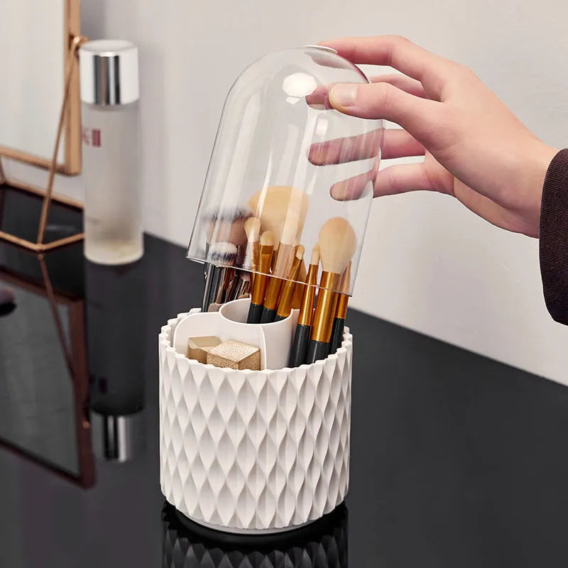 White rotating makeup brush storage box with transparent dust-proof cover on desktop