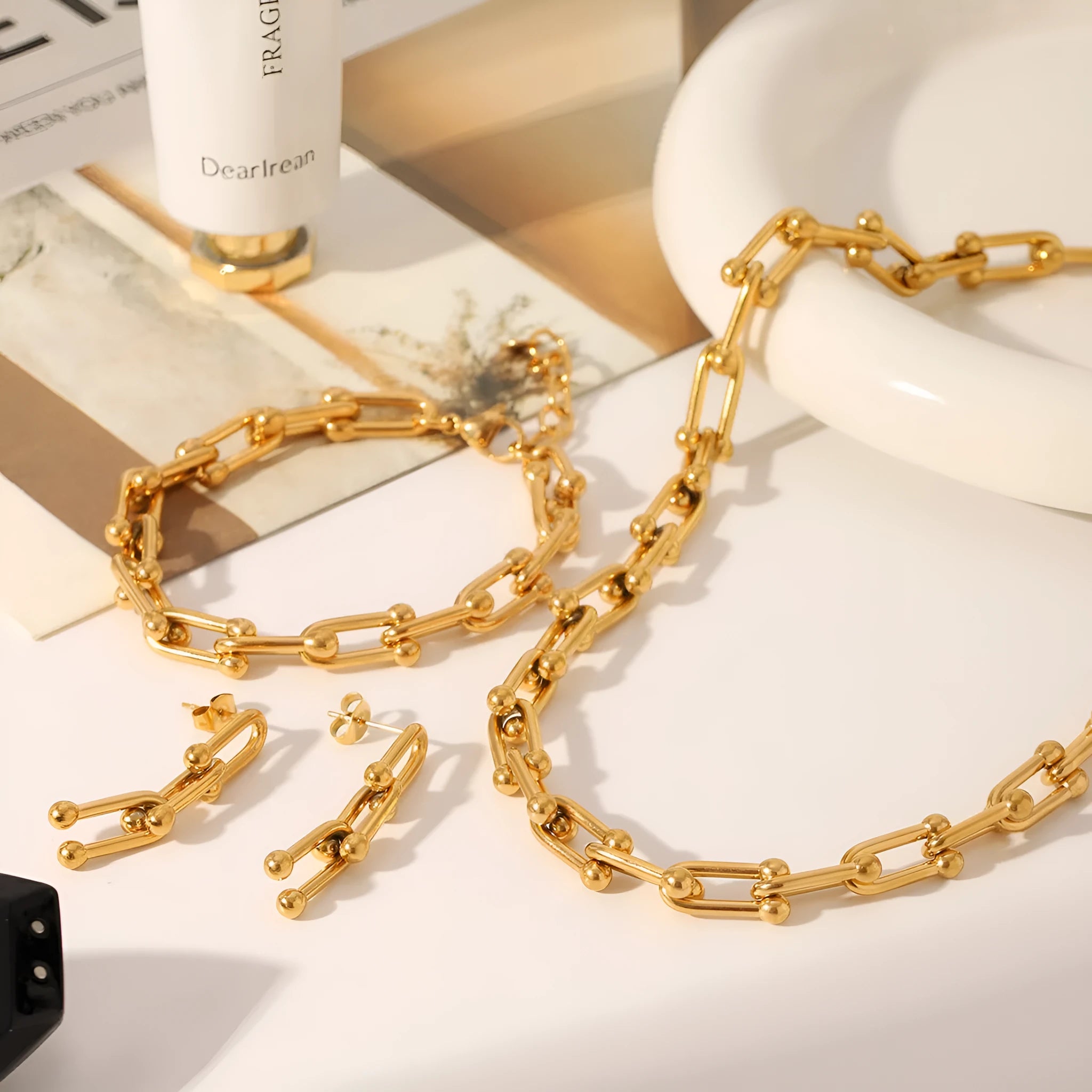 Stainless steel jewellery set with horseshoe design showing necklace, bracelet and earrings in silver finish