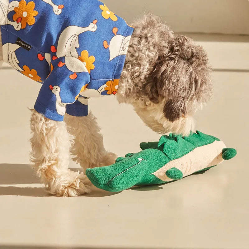 Green plush stuffed toy dog on a white background.