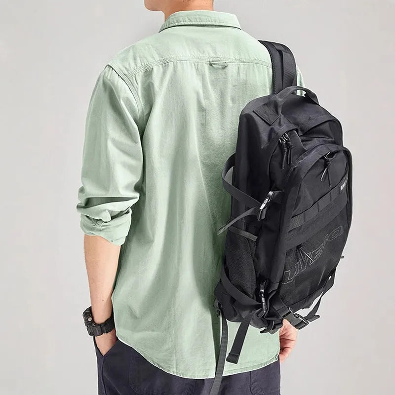 Men's light grey loose fit long sleeve overalls shirt with cardigan style on a hanger