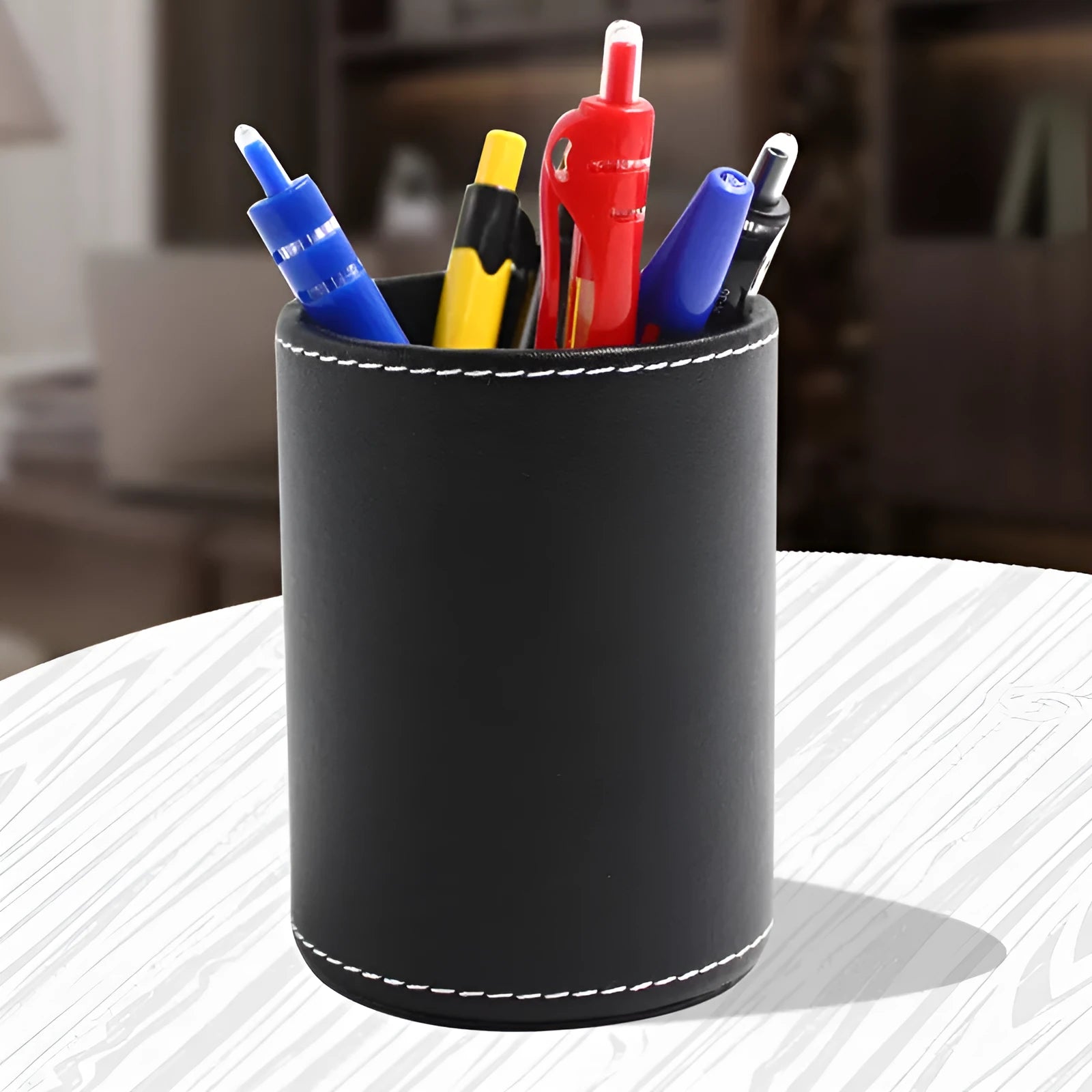 Black leather round pen container with 8.0cm diameter measurement