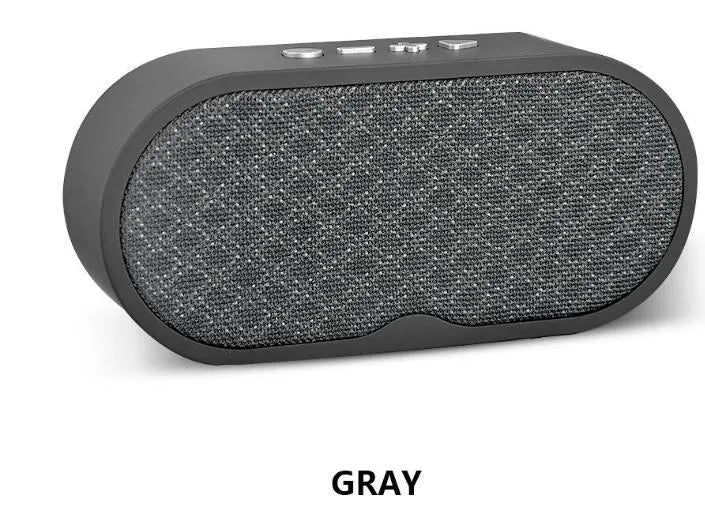 Portable grey Bluetooth speaker with HD microphone on a table