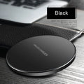 Ultra-thin black wireless charging pad with USB cable on desk
