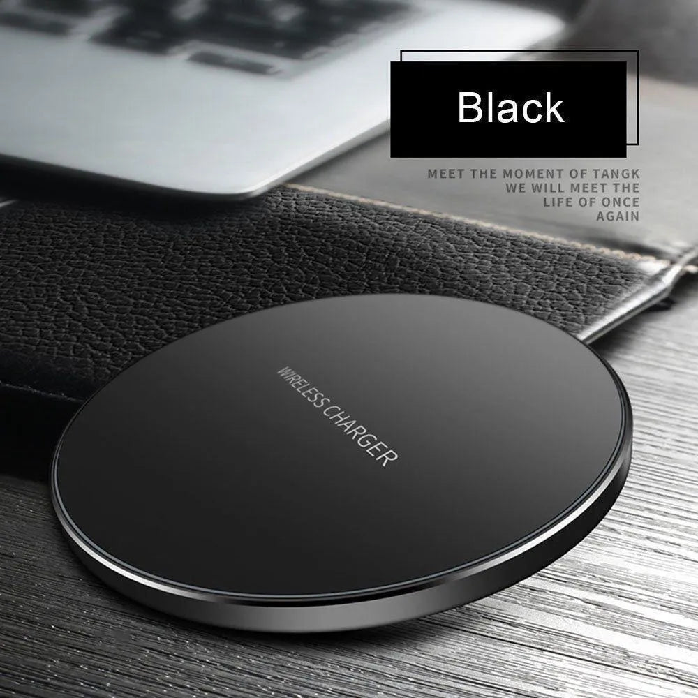 Ultra-thin black wireless charging pad with USB cable on desk