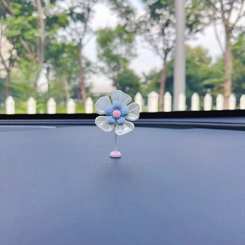 Coloured plastic car decoration swing ornament measuring approximately 5cm by 3.5cm