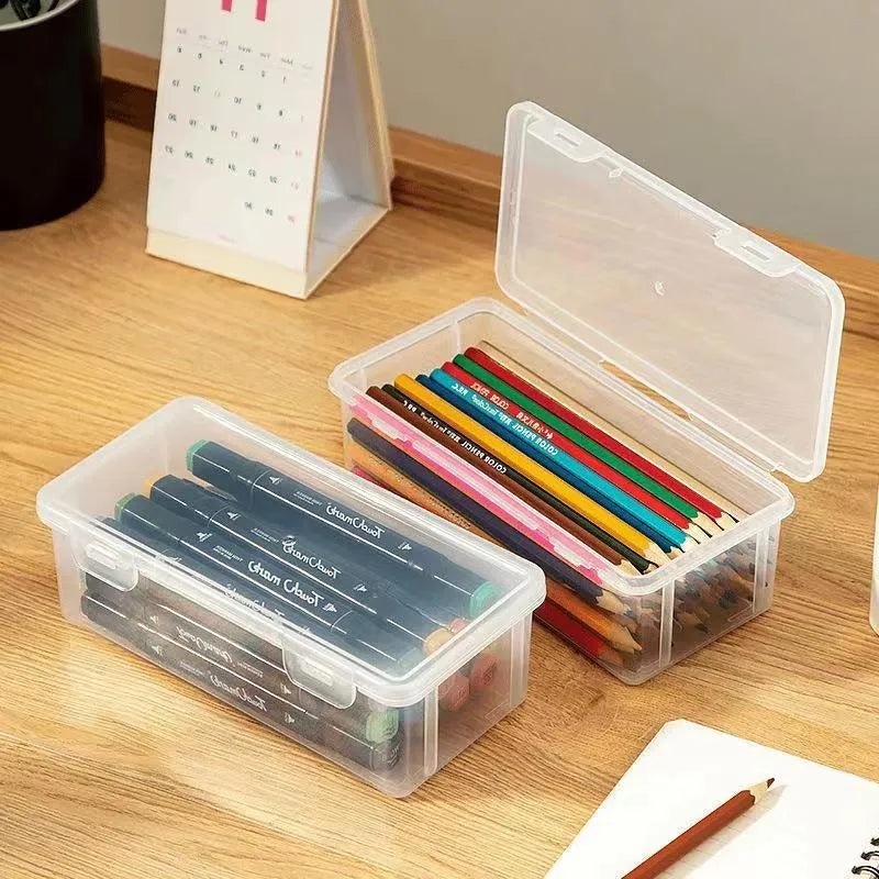 Large transparent plastic stationery storage box filled with coloured pencils and pens