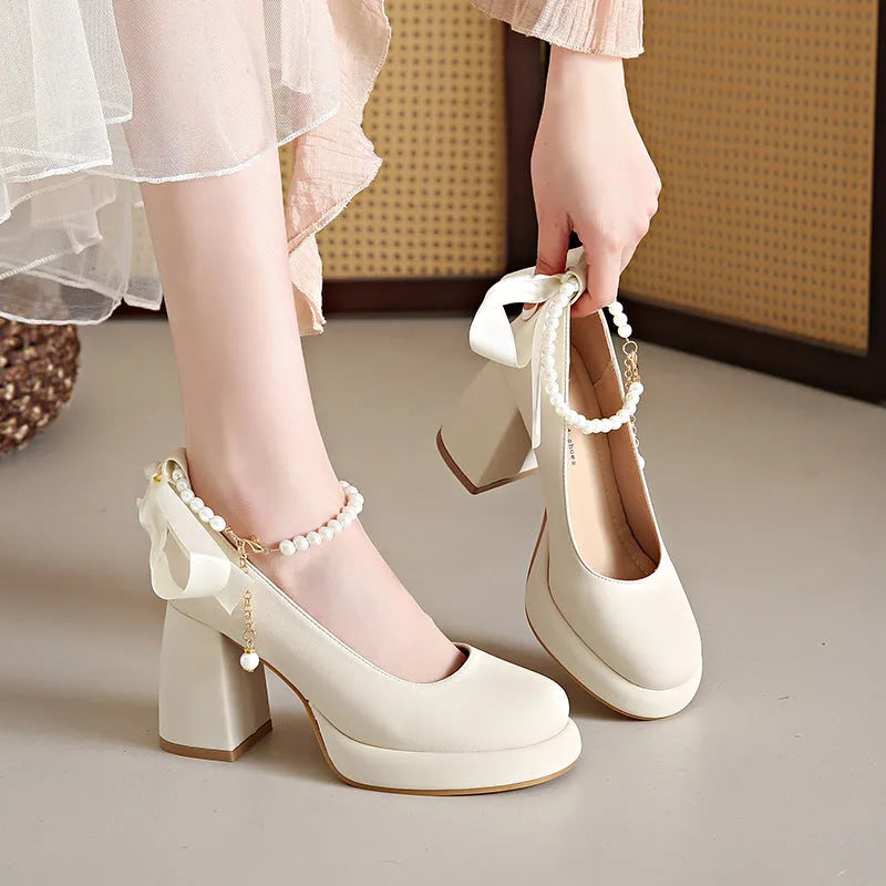 Beige women's Mary Jane shoes with a chunky heel, round toe, and an ankle-strap buckle.