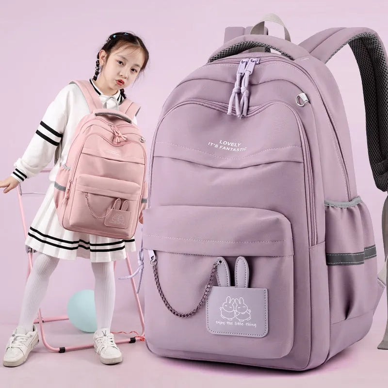 Nylon school backpack 30x21x43cm with letter pattern, available in pink, black, orange, and purple.