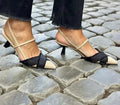 Apricot black women's stiletto heel sandals with pointed toe and buckle fastening on a rubber sole.