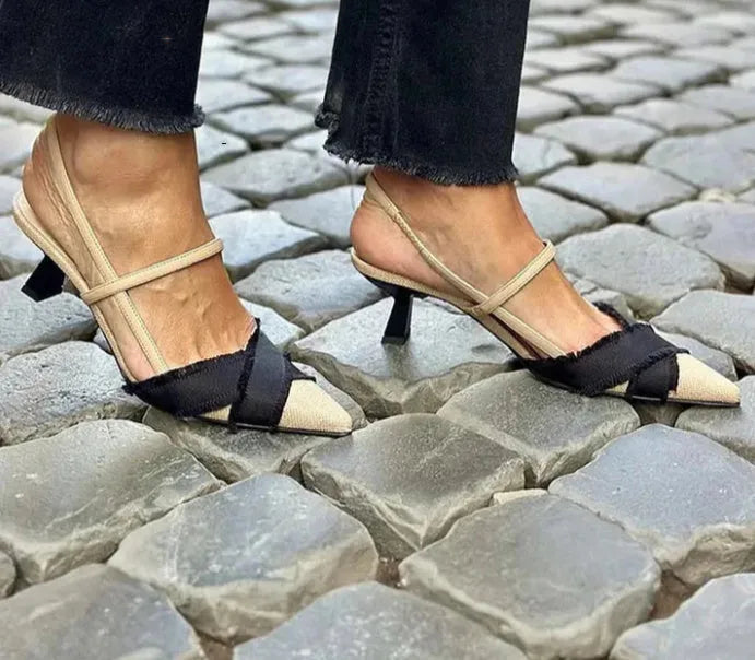 Apricot black women's stiletto heel sandals with pointed toe and buckle fastening on a rubber sole.