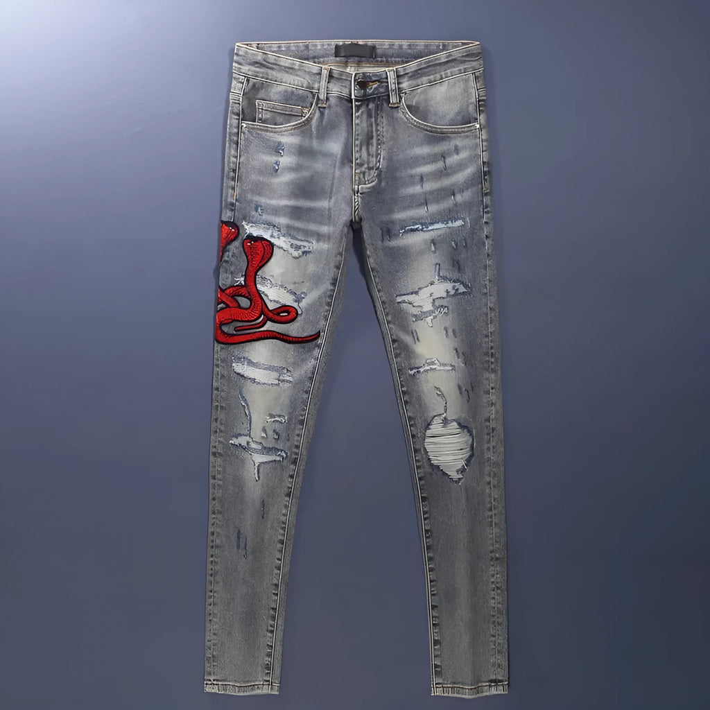 Men's slim fit distressed jeans with embroidered patches in old colour wash