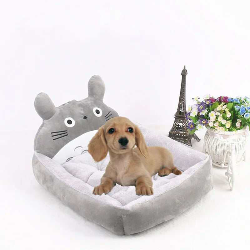 A blue cartoon-style pet sofa bed with raised sides for a small dog, showcasing its washable cover and non-slip base.
