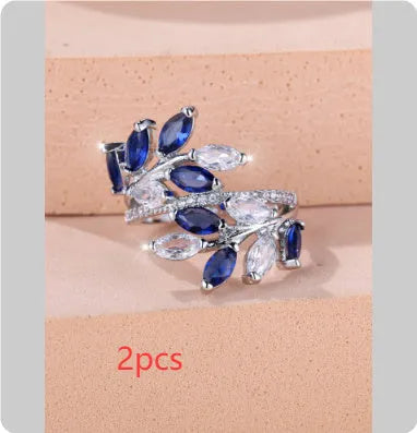 Adjustable leaf ring with horse eye zircon stone in rose gold finish on wooden background