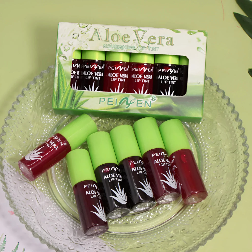 Set of six aloe lip gloss tubes in different colours on a light background