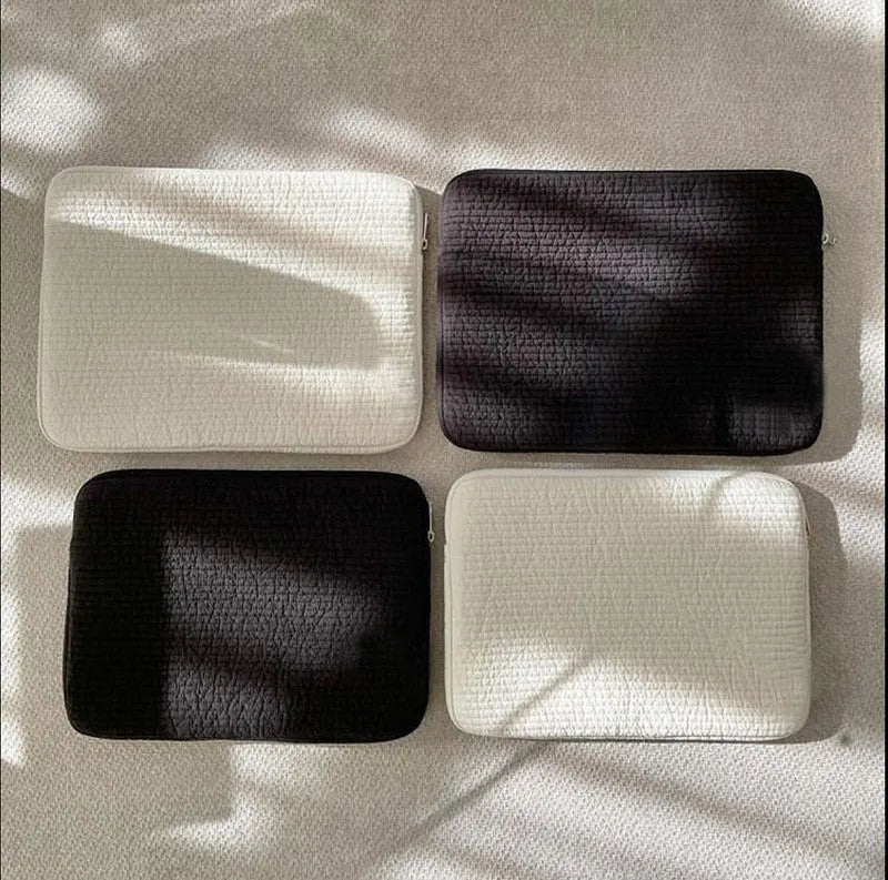 Black and white cotton cloth clutch-style laptop bag with internal coin pocket for anti-seismic tablet protection.