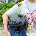 Yellow silicone sunflower decoration with a suction cup base for attaching to a helmet.
