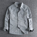 Men's light grey loose fit long sleeve overalls shirt with cardigan style on a hanger