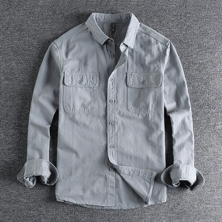 Men's light grey loose fit long sleeve overalls shirt with cardigan style on a hanger