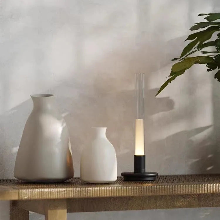Black Nordic style LED table lamp with three-colour lighting modes on a desk
