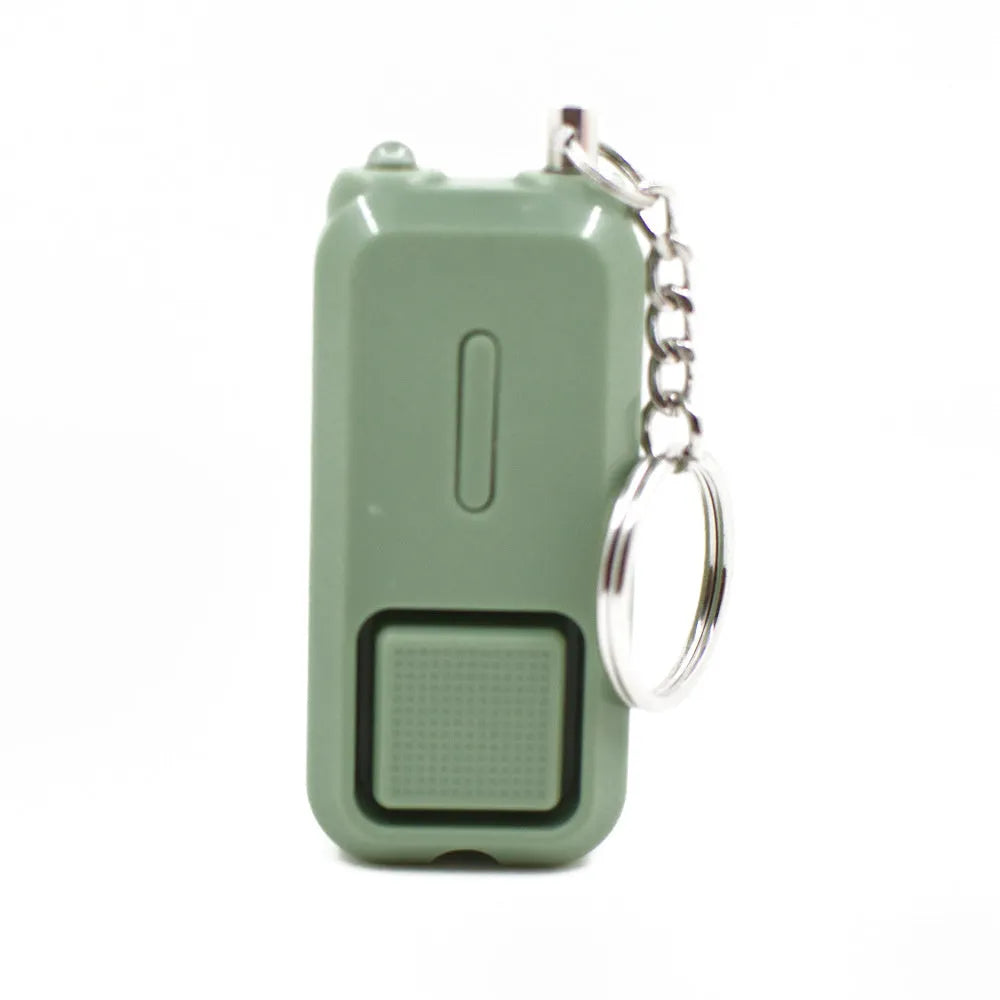 Compact pink personal safety alarm keyring with a button, shown next to its white retail box.