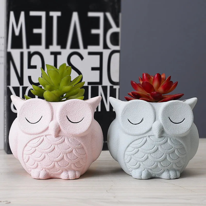 Handmade frosted ceramic flower pot with a cartoon owl design, shown in light pink.