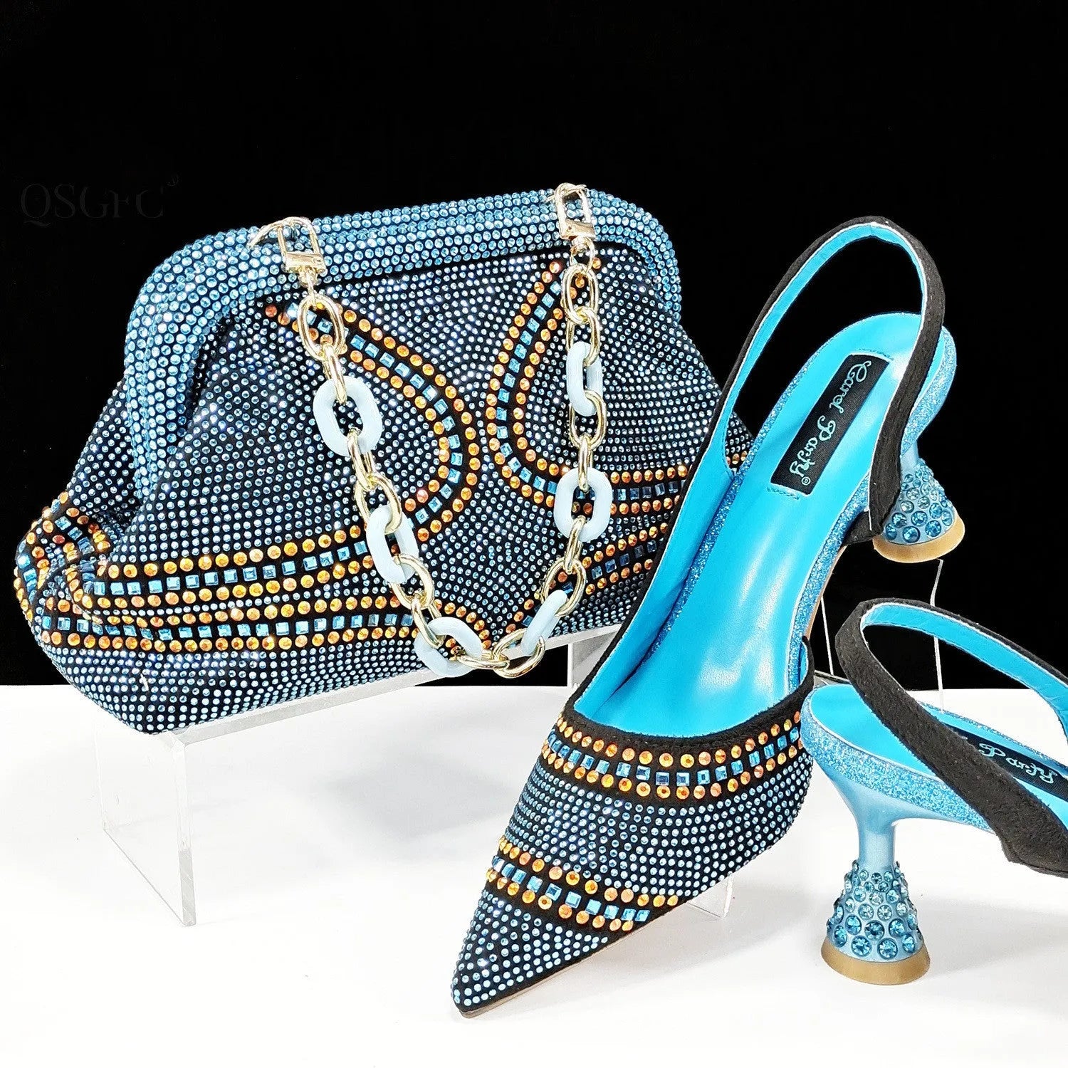 Women's pointed toe high heels with a matching small bag in synthetic leather, shown with a wine glass heel.