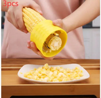 Yellow corn-shaped manual thresher kitchen tool with a non-slip PP grip for removing kernels from corn cobs.