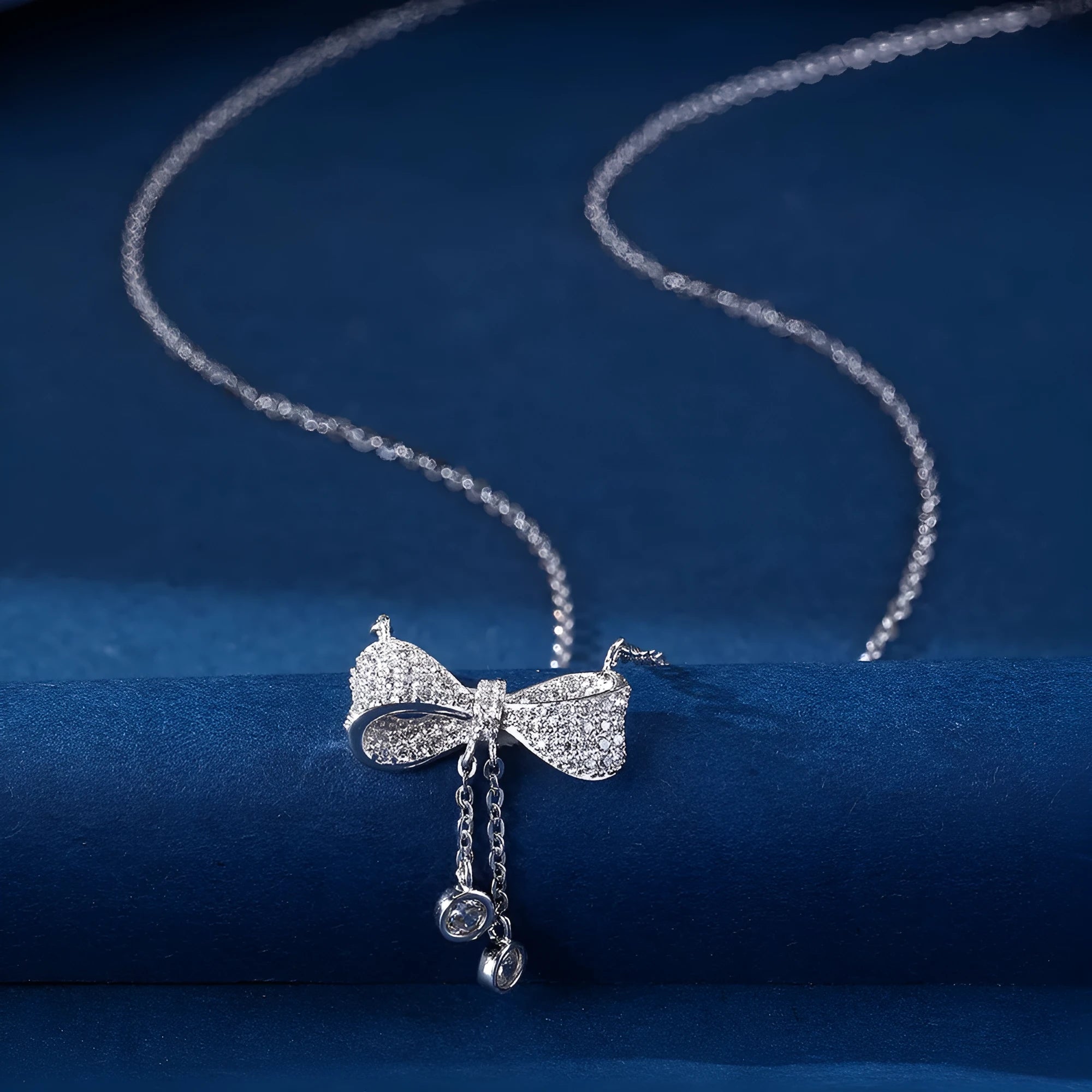 S925 sterling silver necklace with bow pendant on an O-ring chain, shown at clavicle length.