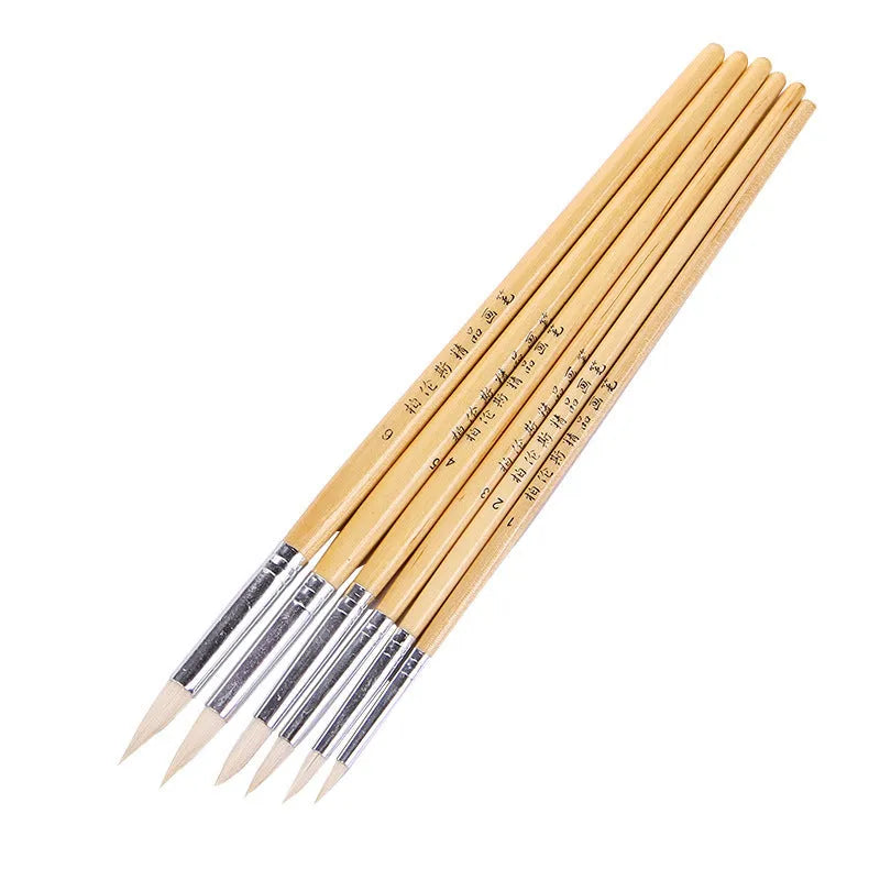Set of six wooden handled hook line pen brushes with wool pointed tips on a white background.