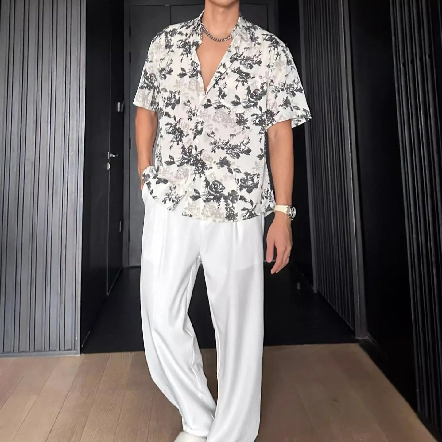 Loose fitting floral printed short sleeve shirt in black on a hanger