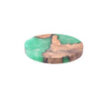 Nordic style wooden coaster in solid colour on a table.