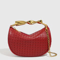 Straw woven dumpling chain crossbody bag in black PU leather with woven texture and chain shoulder strap.