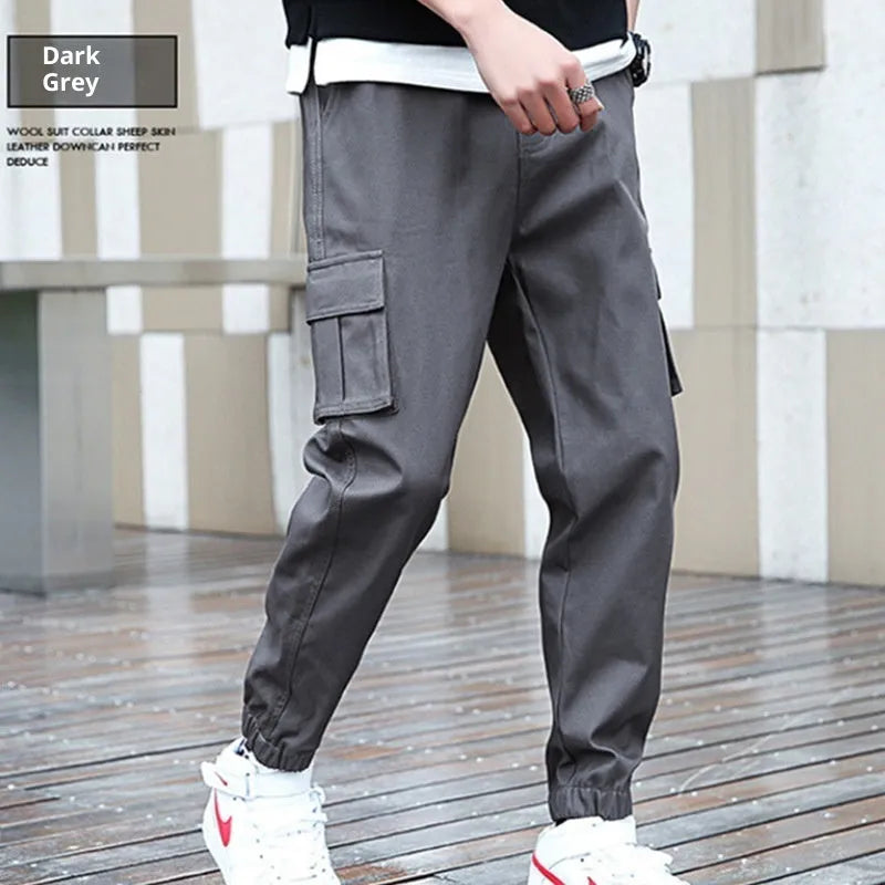 Khaki multi-pocket harem trousers with tapered mid-waist and elastic waistband, polyester fabric